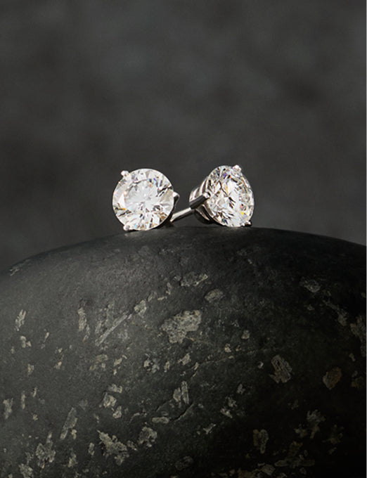 Pair of round diamond stud earrings in white gold