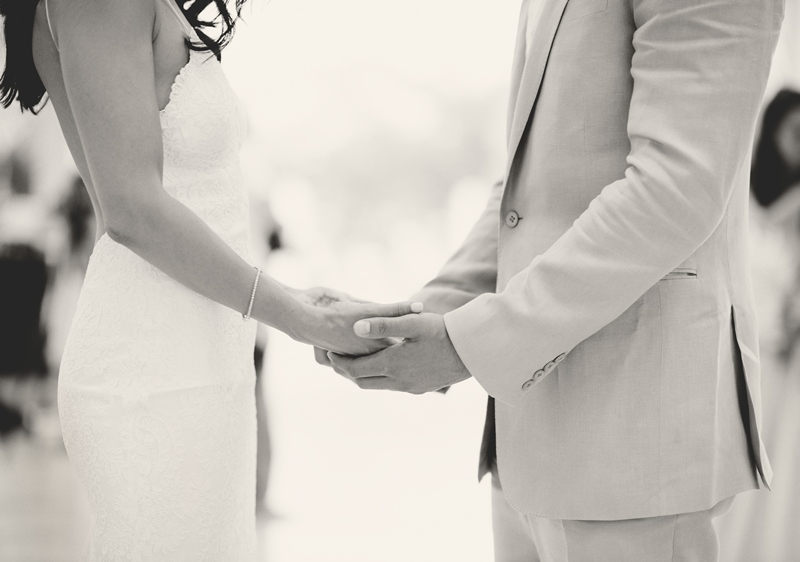 Couple holding hands showing with womens wedding band
