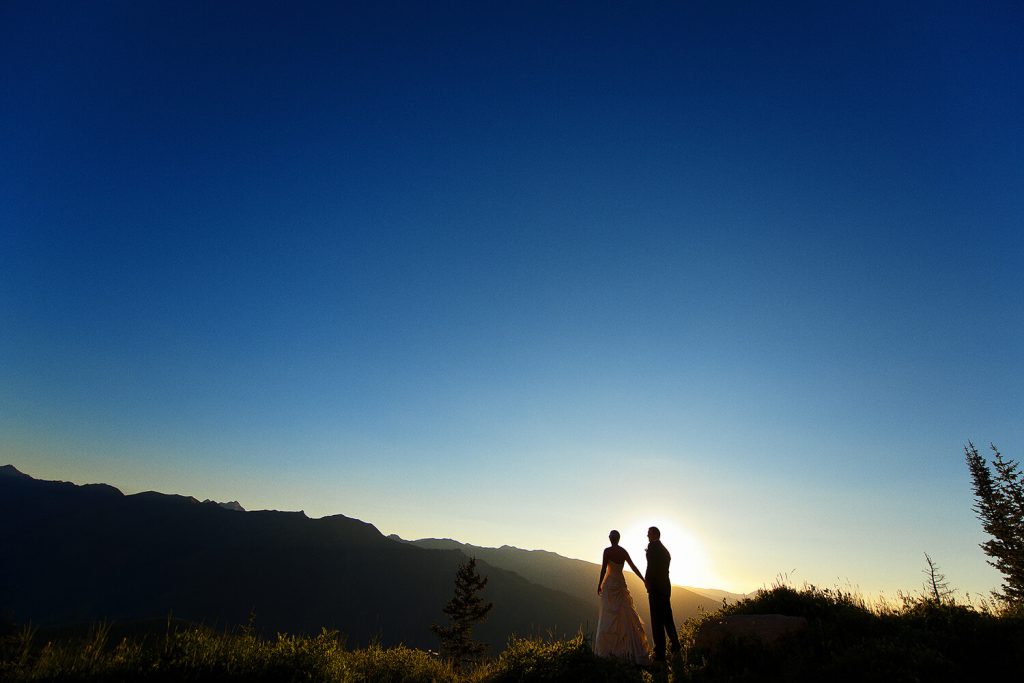 Bride and groom looking at the sunset