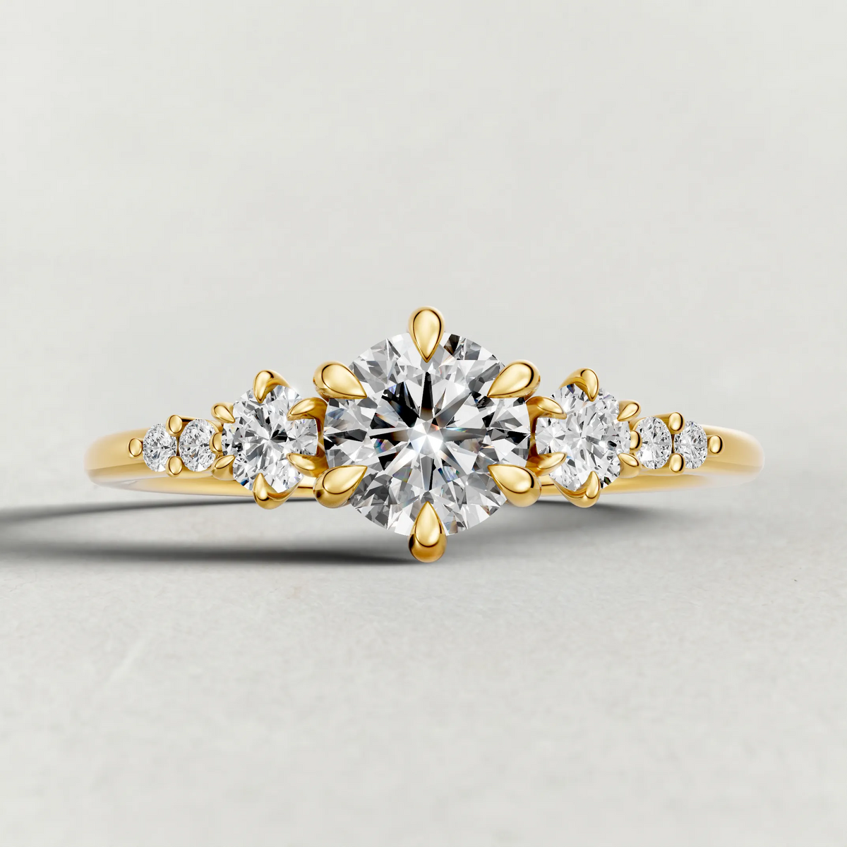 Graduated Side-Stone Engagement Ring (72084) in Yellow Gold zoomed in on diamond