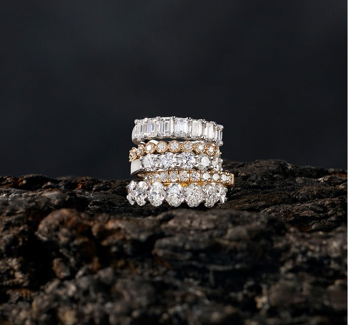 Stack of five diamond anniversary bands in white and yellow gold
