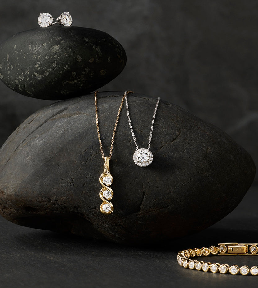 Diamond stud earrings, twist and halo pendants, and a yellow gold tennis bracelet