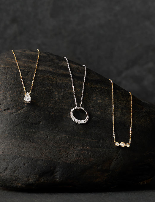 Pear, circle and three-stone diamond pendants