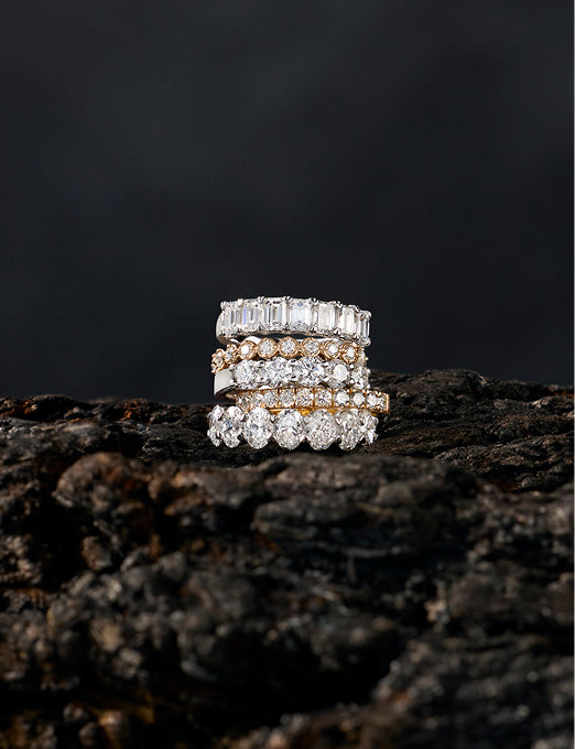 Stacked diamond bands with emerald, round and oval cut stones